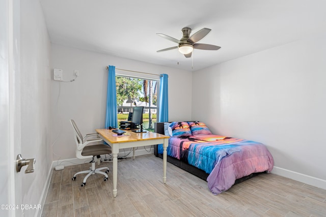 bedroom with ceiling fan and light hardwood / wood-style flooring