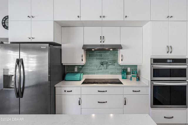 kitchen with decorative backsplash, white cabinetry, and stainless steel appliances