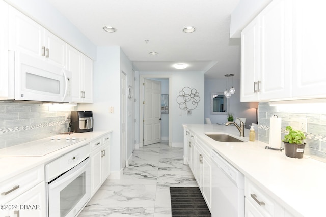 kitchen featuring white cabinets, white appliances, sink, and backsplash