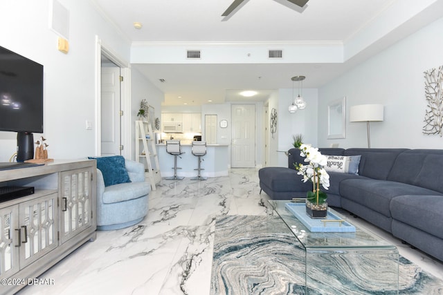 living room featuring ceiling fan and ornamental molding