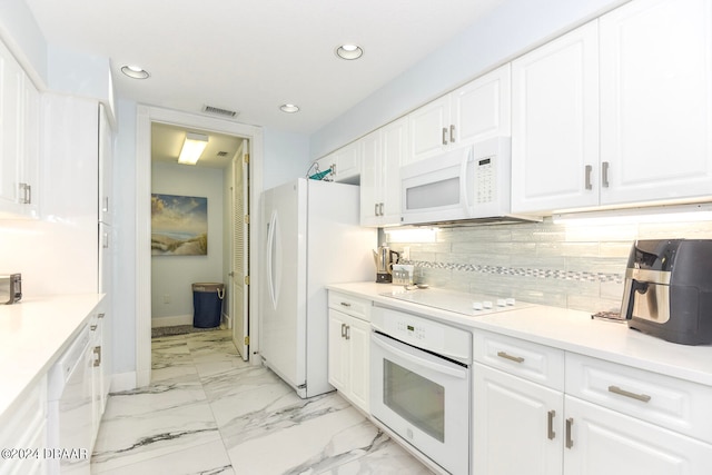 kitchen with white cabinets, white appliances, and tasteful backsplash