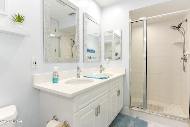 bathroom featuring toilet, vanity, and an enclosed shower