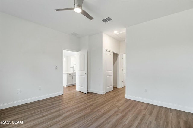 unfurnished bedroom with light hardwood / wood-style flooring, a closet, and ceiling fan