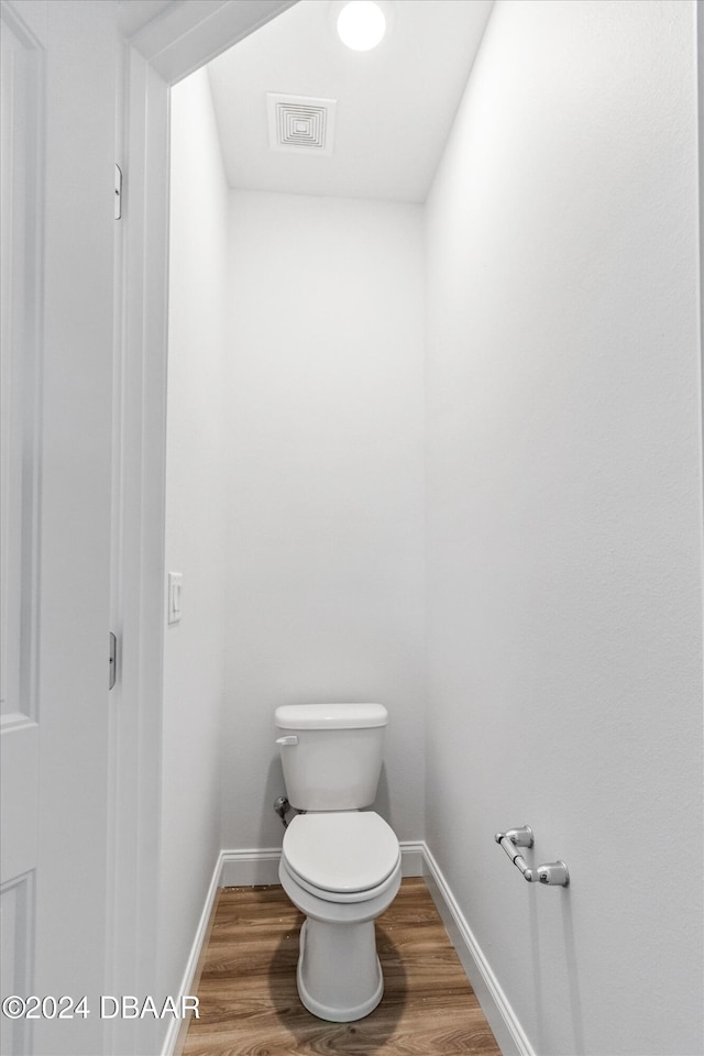 bathroom with wood-type flooring and toilet