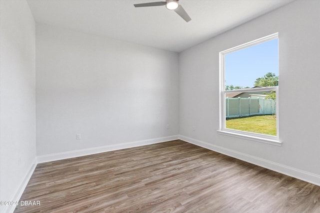 empty room with hardwood / wood-style flooring and ceiling fan