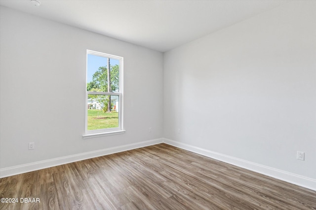 unfurnished room featuring wood-type flooring and plenty of natural light