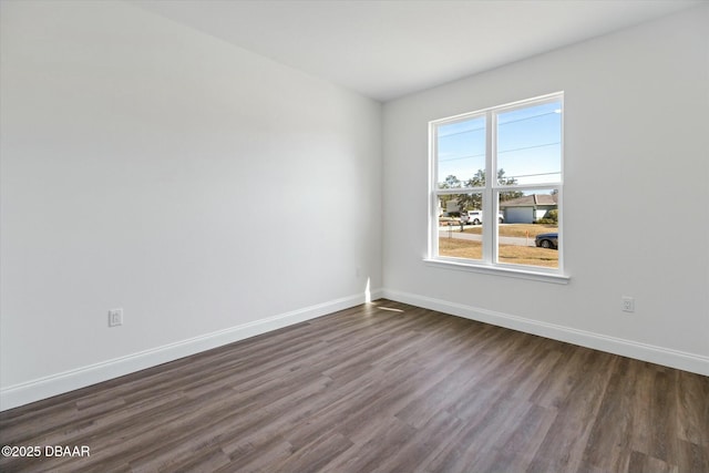 unfurnished room with dark wood-type flooring