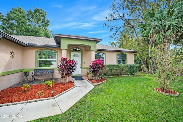 ranch-style house featuring a front yard