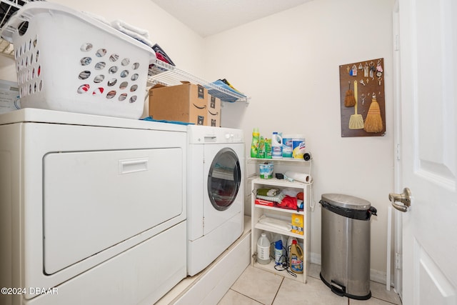 washroom featuring light tile patterned floors and washer and clothes dryer