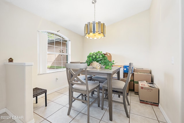 tiled dining room with an inviting chandelier