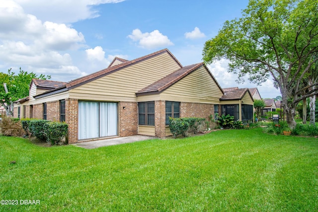 rear view of house with a yard