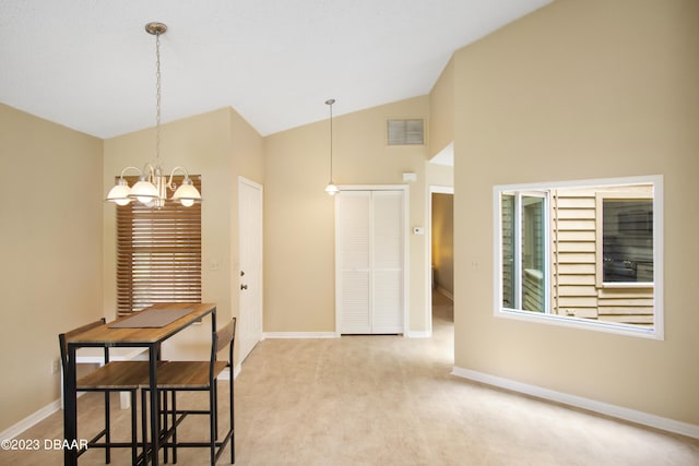 dining area featuring an inviting chandelier, vaulted ceiling, light carpet, and a healthy amount of sunlight