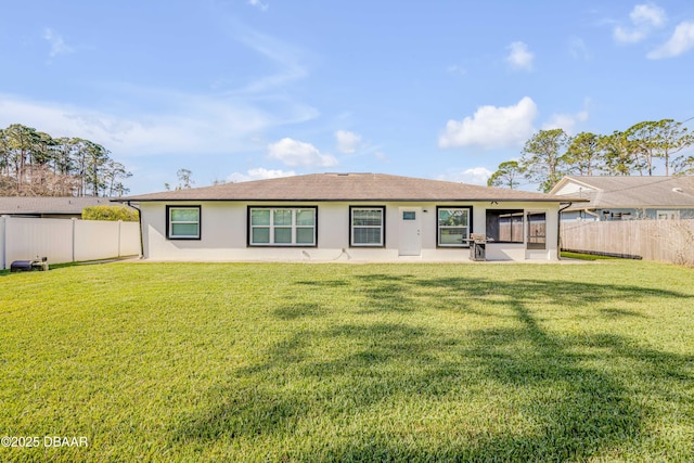 back of house featuring a patio, a fenced backyard, a lawn, and stucco siding