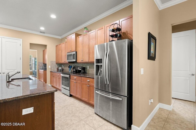 612 Aldenham Ln, Ormond Beach, FL 32174 - kitchen featuring appliances with stainless steel finishes, a sink, light tile patterned flooring, decorative backsplash, and dark stone countertops