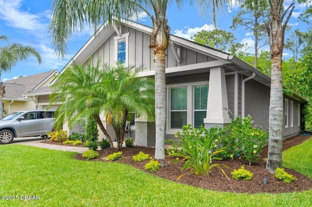 612 Aldenham Ln, Ormond Beach, FL 32174 - view of home's exterior with board and batten siding and a yard