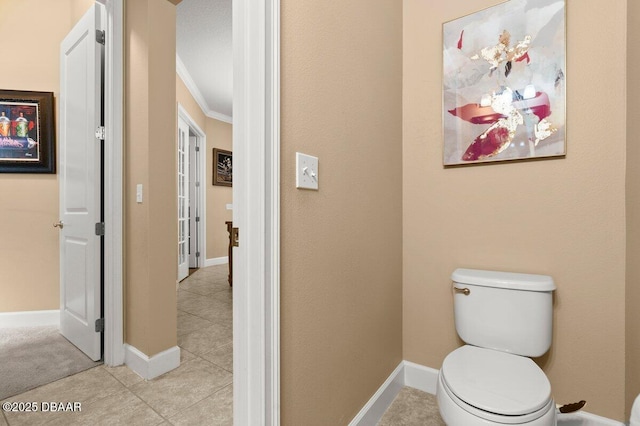 612 Aldenham Ln, Ormond Beach, FL 32174 - bathroom featuring ornamental molding, tile patterned flooring, toilet, and baseboards