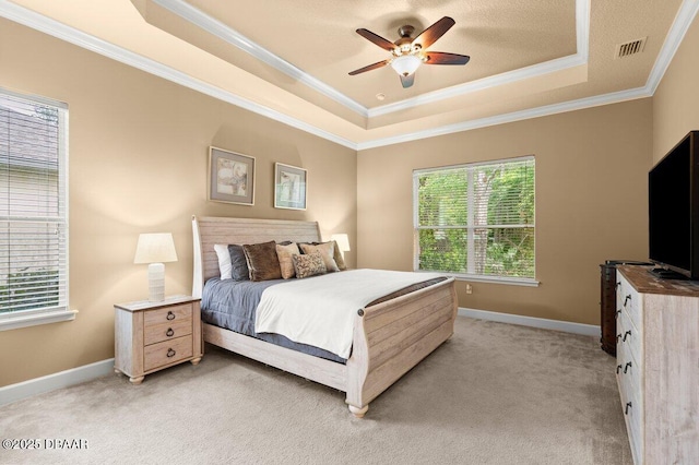 612 Aldenham Ln, Ormond Beach, FL 32174 - bedroom featuring a tray ceiling, crown molding, light colored carpet, baseboards, and ceiling fan
