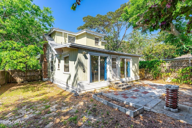 1011 S Peninsula Dr, Daytona Beach, FL 32118 - rear view of house with a fenced backyard, a patio, and entry steps