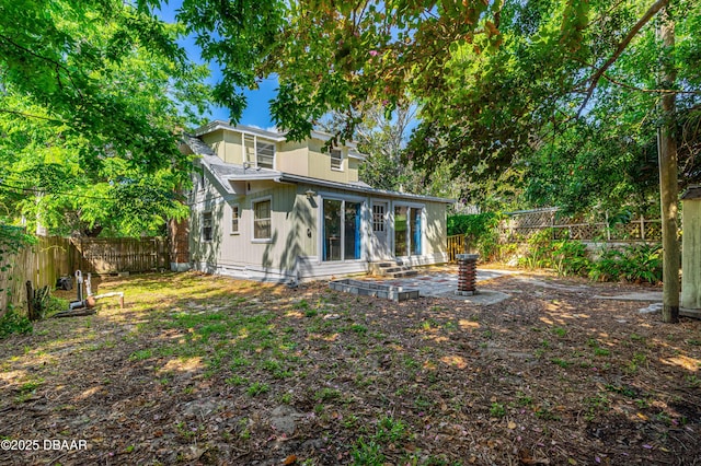1011 S Peninsula Dr, Daytona Beach, FL 32118 - rear view of house featuring a fenced backyard and a patio area