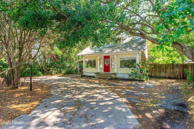 1011 S Peninsula Dr, Daytona Beach, FL 32118 - view of front facade featuring concrete driveway, a shingled roof, and entry steps