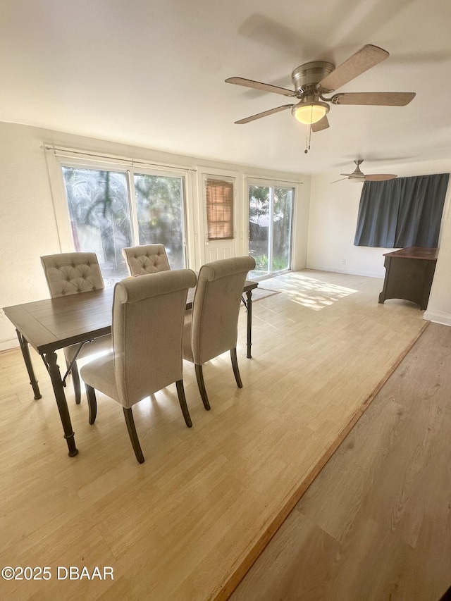 1011 S Peninsula Dr, Daytona Beach, FL 32118 - dining area with light wood-style flooring, ceiling fan, and baseboards