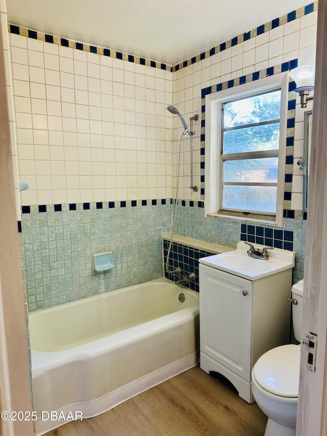 1011 S Peninsula Dr, Daytona Beach, FL 32118 - full bath featuring wood finished floors, toilet, shower / tub combination, vanity, and tile walls