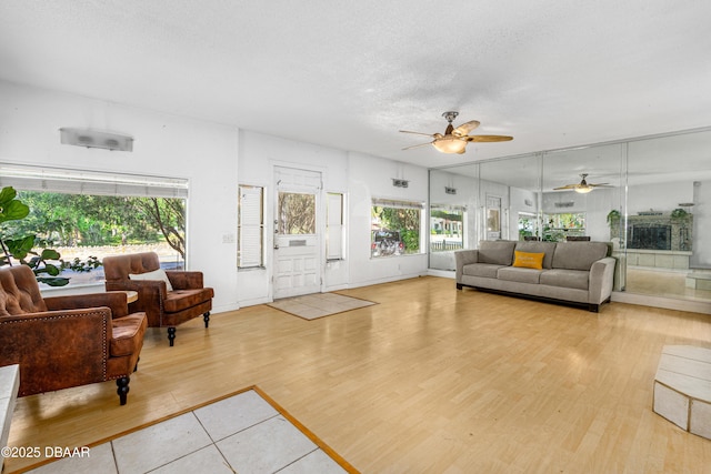 1011 S Peninsula Dr, Daytona Beach, FL 32118 - living area featuring a ceiling fan, light wood-style flooring, and a textured ceiling