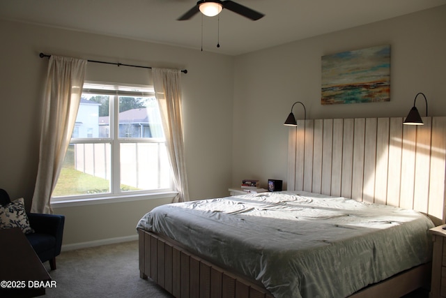 bedroom with multiple windows, light carpet, and ceiling fan