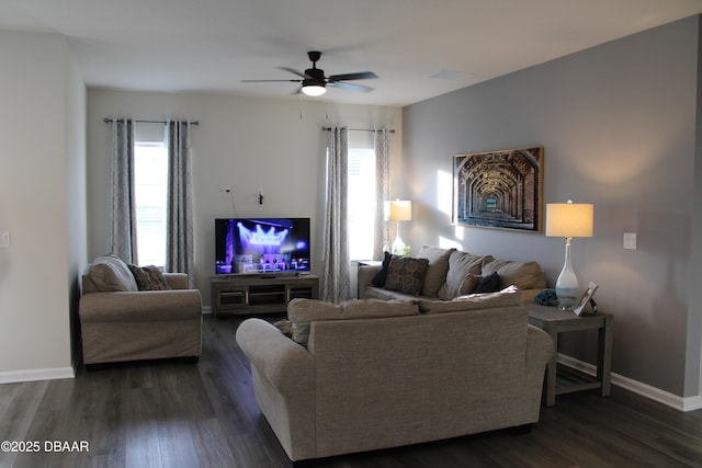 living room featuring a healthy amount of sunlight, dark hardwood / wood-style floors, and ceiling fan