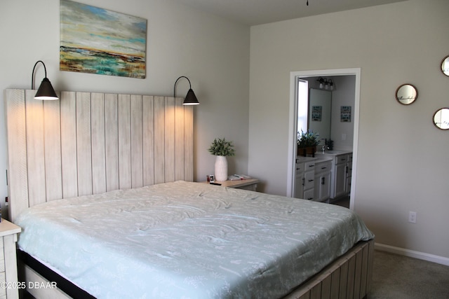 bedroom featuring ensuite bathroom and carpet floors