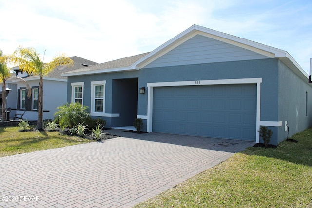 ranch-style home featuring a garage and a front yard