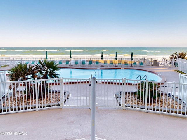 1133 Ocean Shore Blvd Unit 204, Ormond Beach, FL 32176 - view of swimming pool with a beach view, a water view, and fence