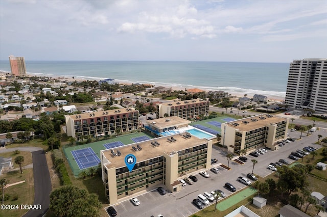 drone / aerial view with a water view and a beach view