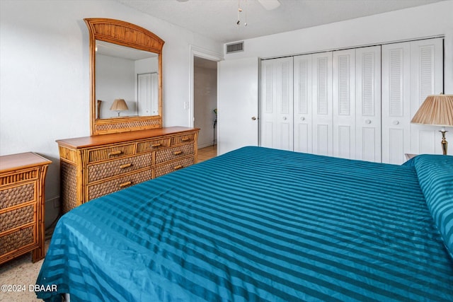 bedroom with ceiling fan, carpet flooring, and a closet