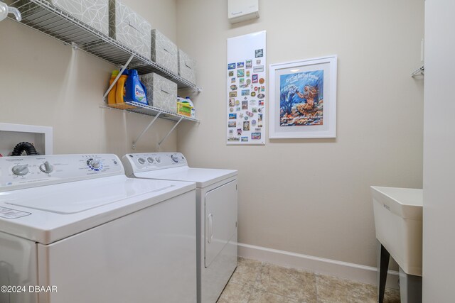 laundry area with light tile patterned flooring and separate washer and dryer