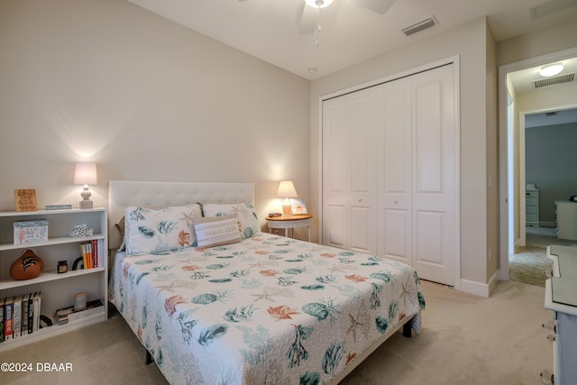 carpeted bedroom with a closet and ceiling fan