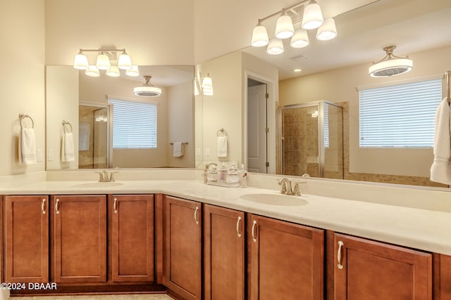 bathroom with a shower with shower door and vanity