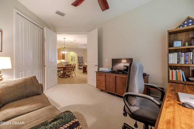 home office with light carpet and ceiling fan