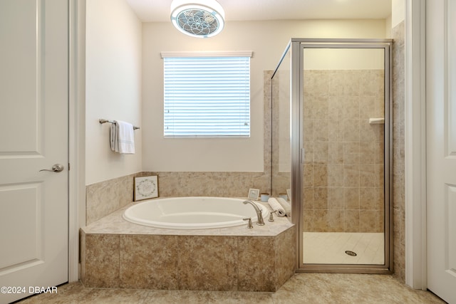 bathroom featuring shower with separate bathtub