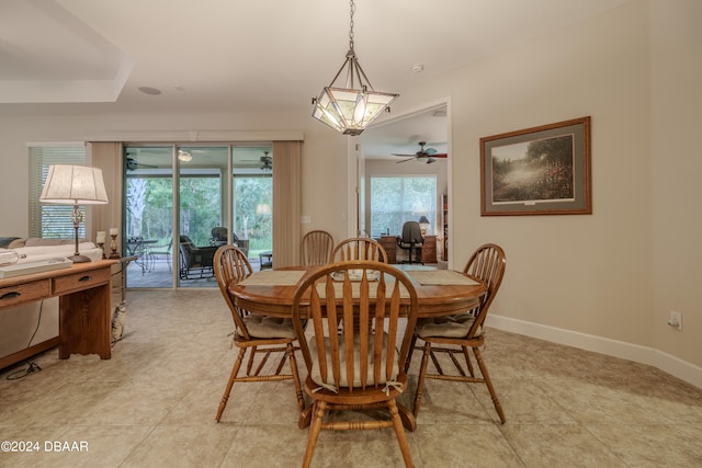 dining space featuring ceiling fan with notable chandelier and light tile patterned floors