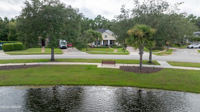 surrounding community featuring a yard and a water view