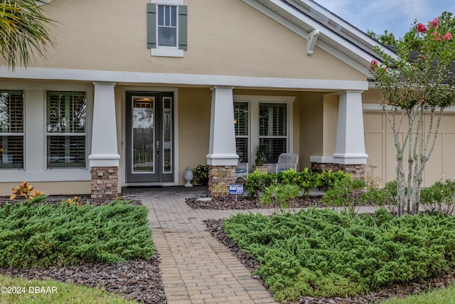 view of exterior entry featuring a porch