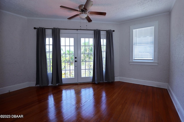 empty room with french doors, crown molding, a textured ceiling, dark wood-type flooring, and ceiling fan