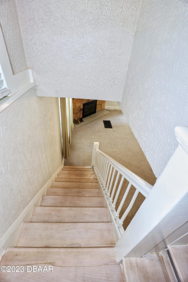 staircase with a textured ceiling