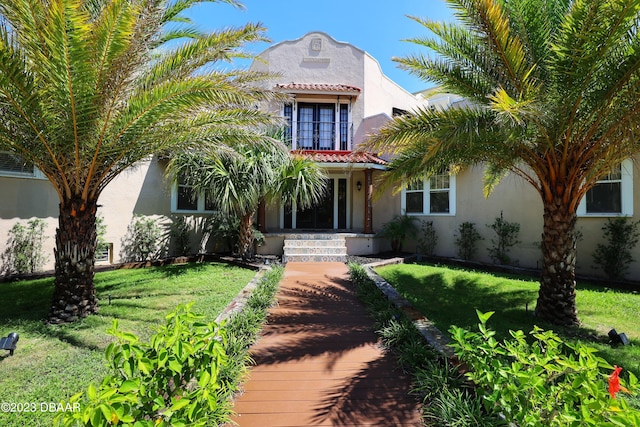 mediterranean / spanish-style house with a front yard