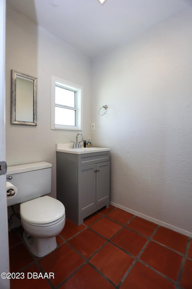 bathroom with vanity, tile patterned floors, and toilet