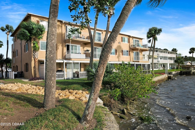 view of property featuring a water view and central air condition unit