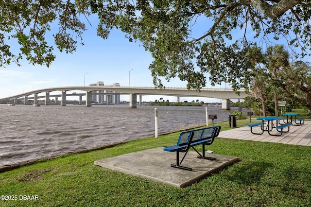 surrounding community featuring a water view and a yard