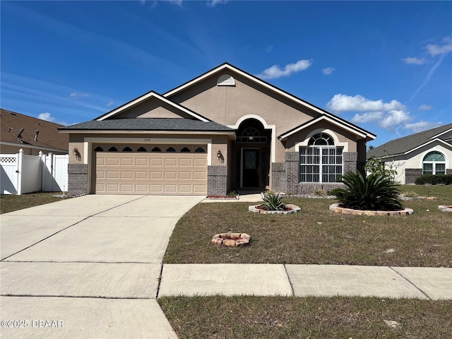 ranch-style home featuring concrete driveway, brick siding, fence, and an attached garage