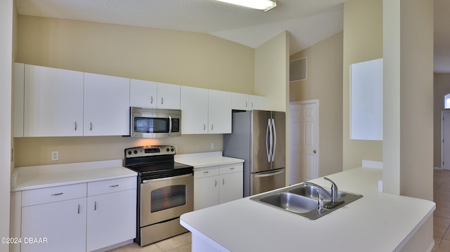 kitchen featuring light tile patterned flooring, white cabinetry, sink, and appliances with stainless steel finishes